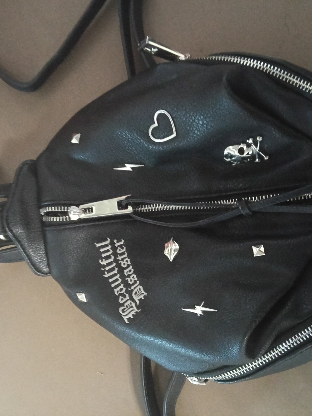 Beautiful Disaster Studded Leather Crossbody Backpack with Silver Accents